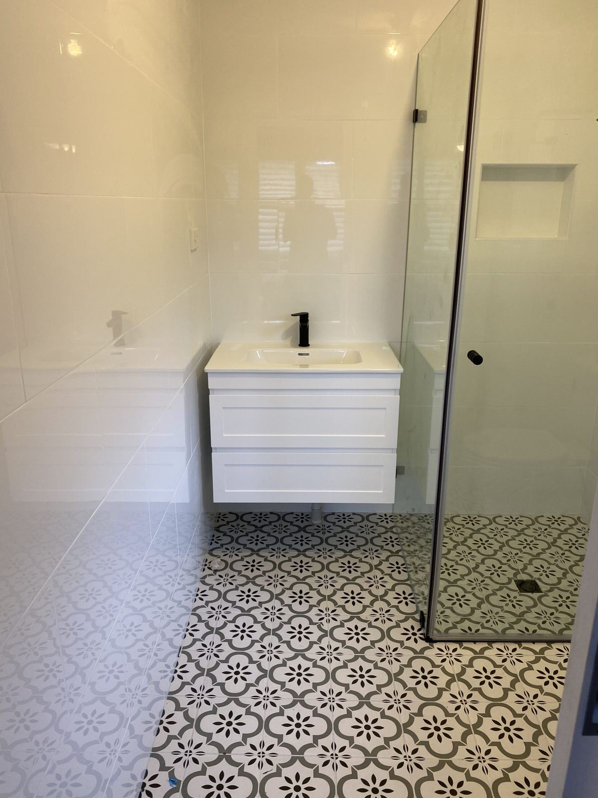 Bathroom renovation with patterned floor tiles