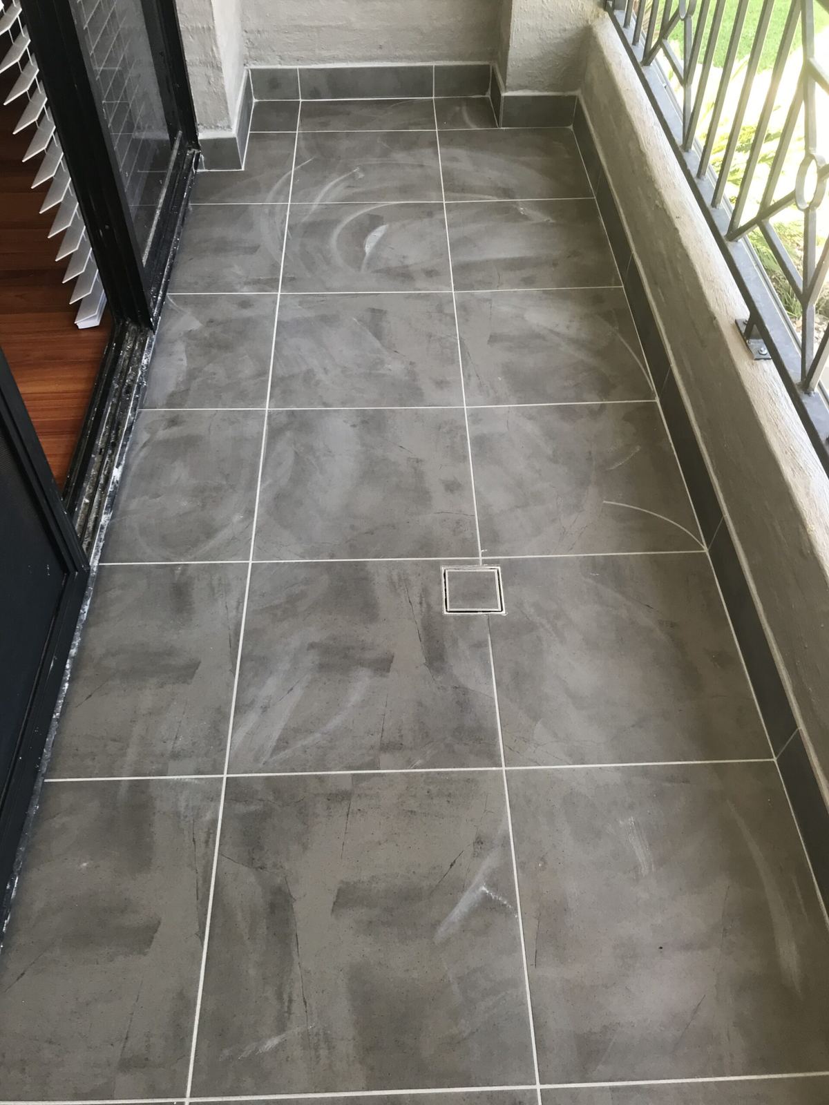 Tiled hallway with plantation shutters